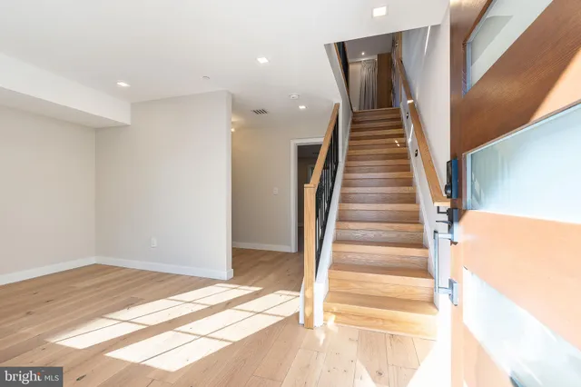 a view of a living room with wooden floor