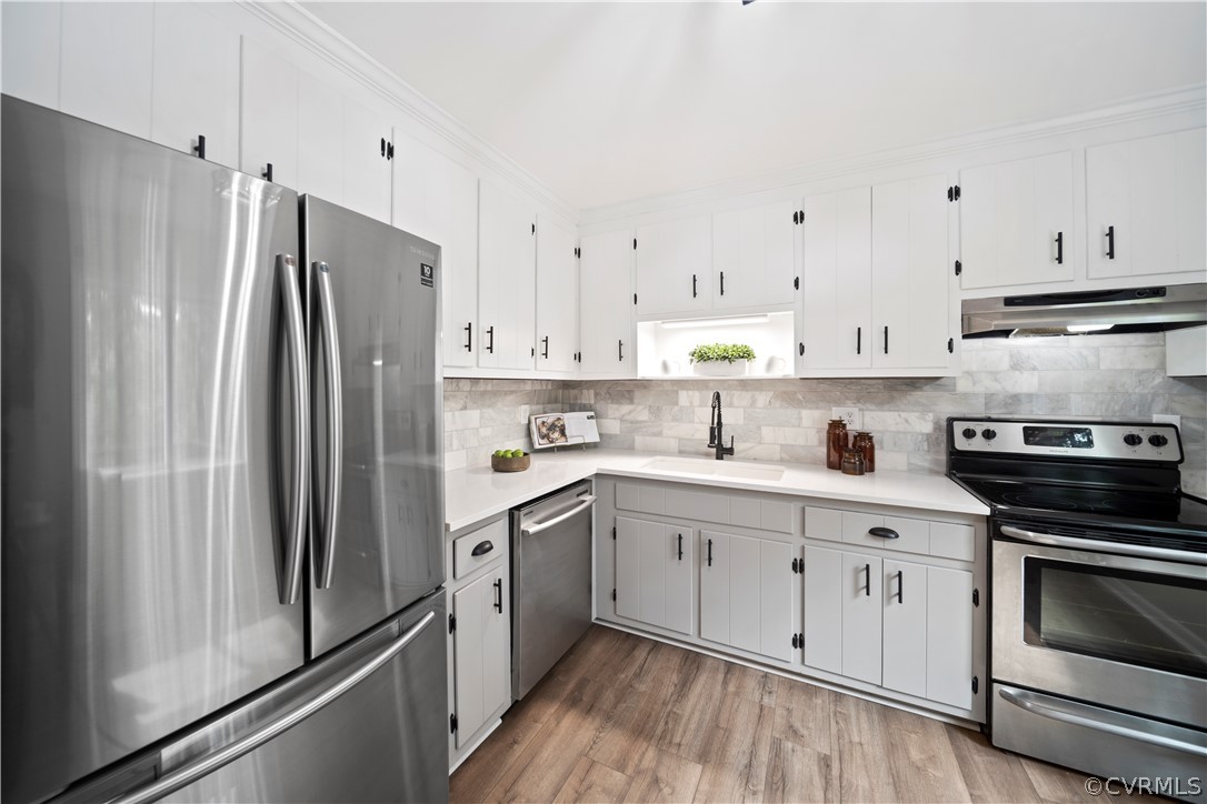 10911 Berrand Road North Chesterfield, VA 23236 - Photo 15 of 44 a kitchen with cabinets stainless steel appliances and wooden floor