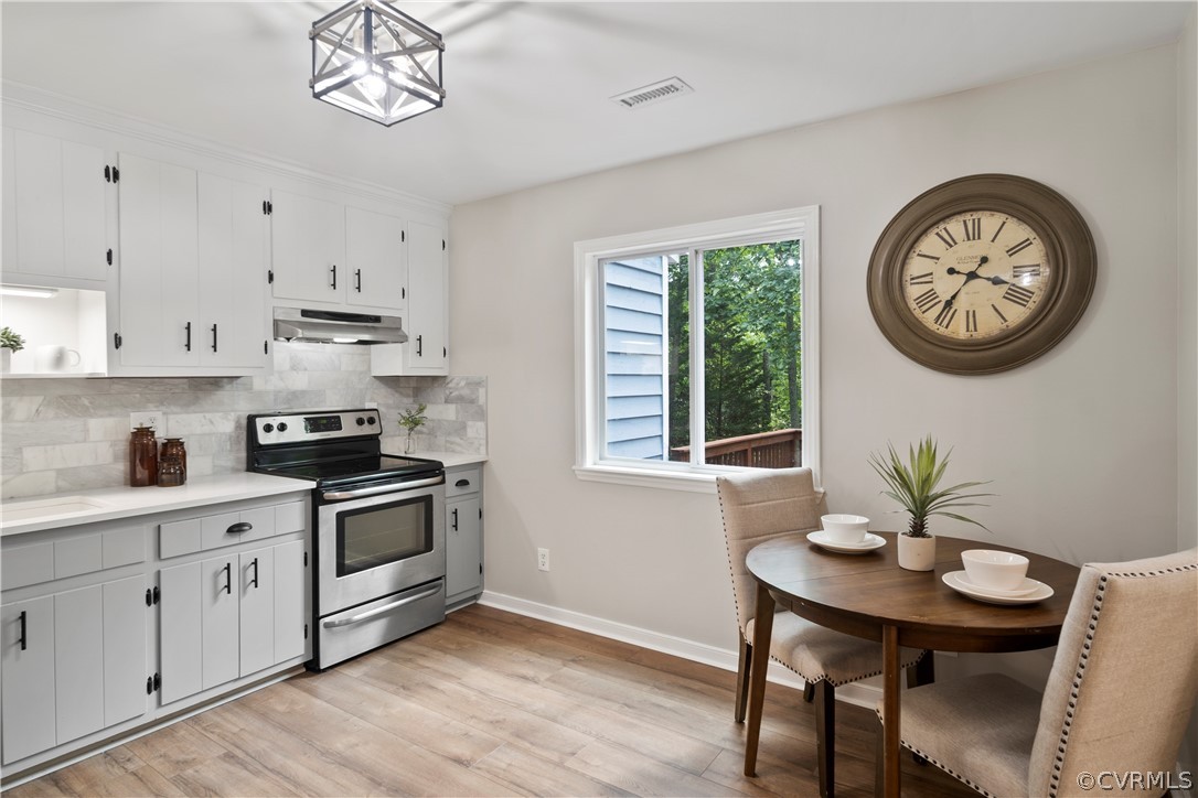 10911 Berrand Road North Chesterfield, VA 23236 - Photo 20 of 44 a kitchen with stainless steel appliances a white stove top oven a clock and a window