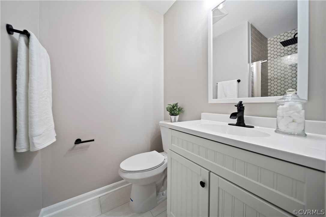 10911 Berrand Road North Chesterfield, VA 23236 - Photo 23 of 44 a bathroom with a sink a toilet and shower