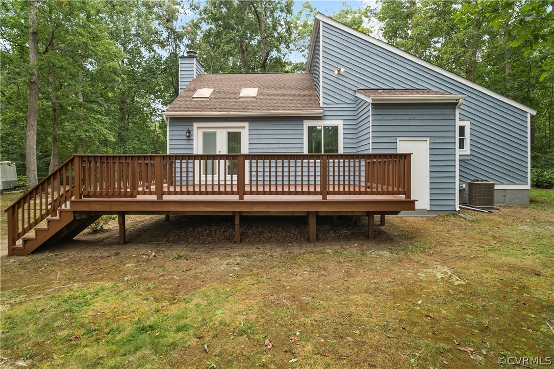 10911 Berrand Road North Chesterfield, VA 23236 - Photo 5 of 44 a view of a house with a deck and a yard