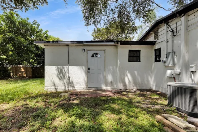 a backyard of a house with table and chairs