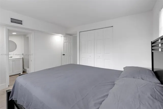 a bedroom with a bed and a mirror