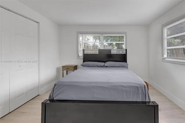 a bedroom with a bed and window