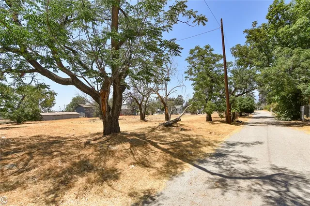 a view of a yard covered with snow in front of house