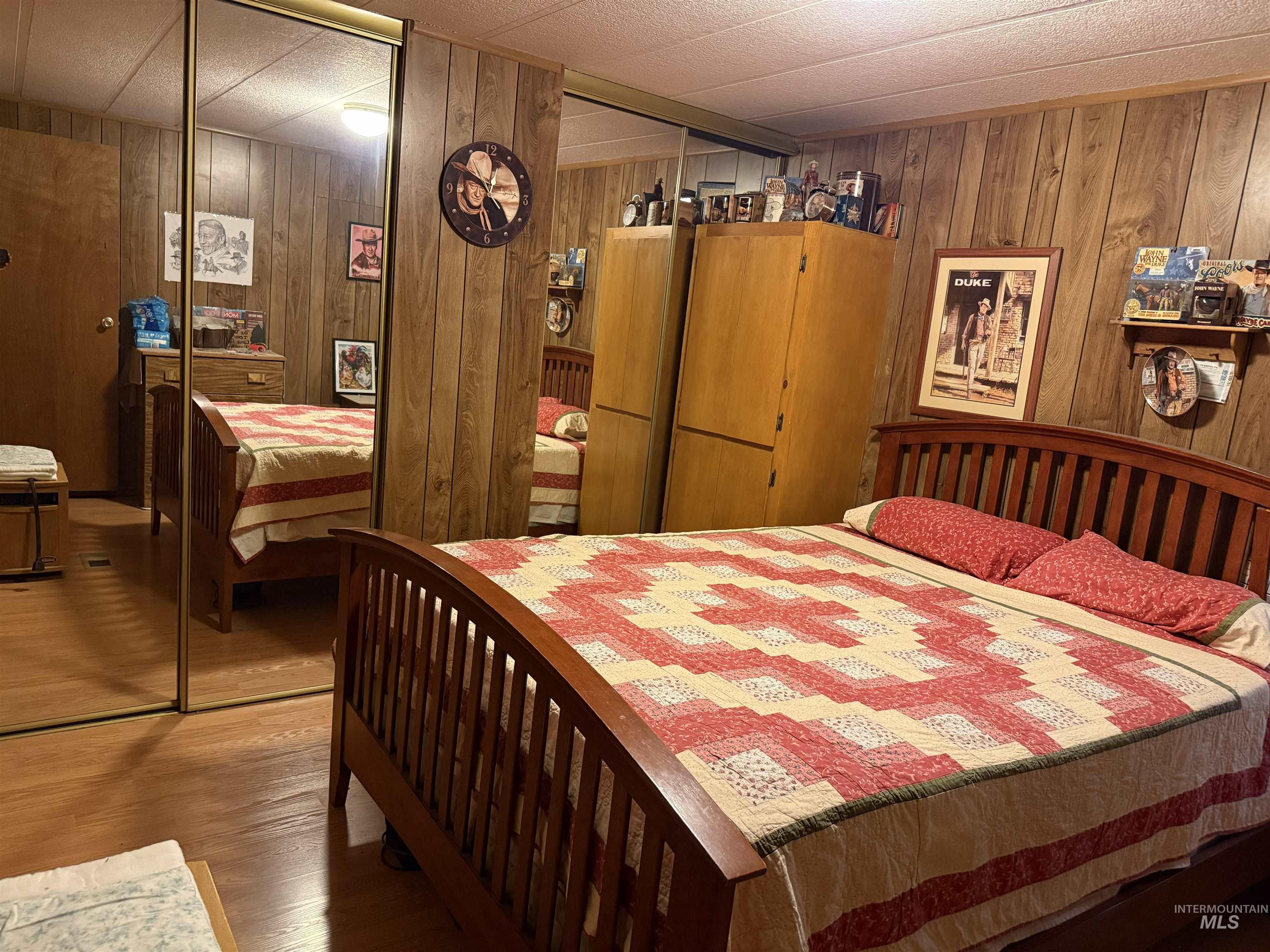 733 Pleasant Valley Road Stites, ID 83552 - Photo 12 of 46 Bedroom featuring wood-finish paneling and wood-finish flooring