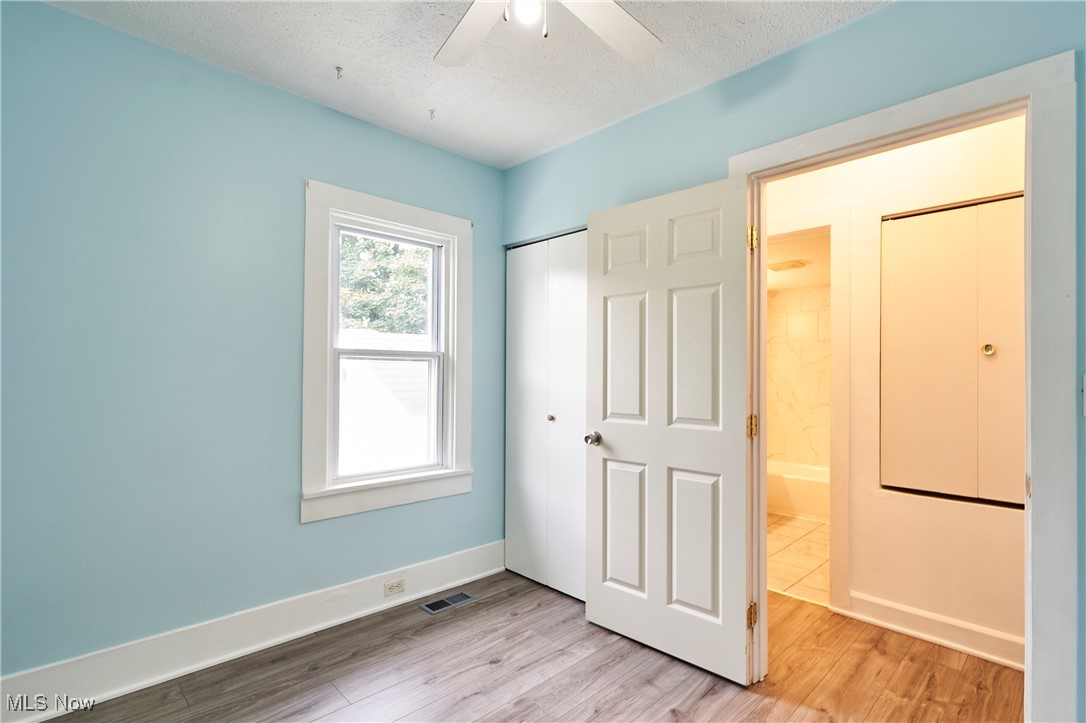 1001 Dayton Street Akron, OH 44310 - Photo 14 of 27 Bedroom with Fresh paint,LVT flooring and new ceiling fan