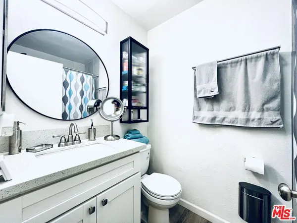 a bathroom with a sink mirror and vanity