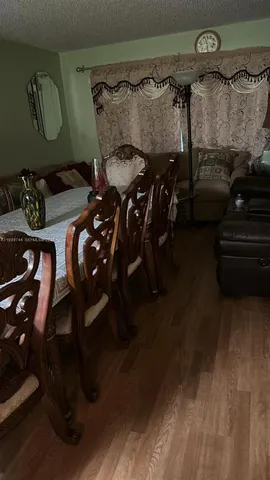 a room with a sink and a stove with wooden floor