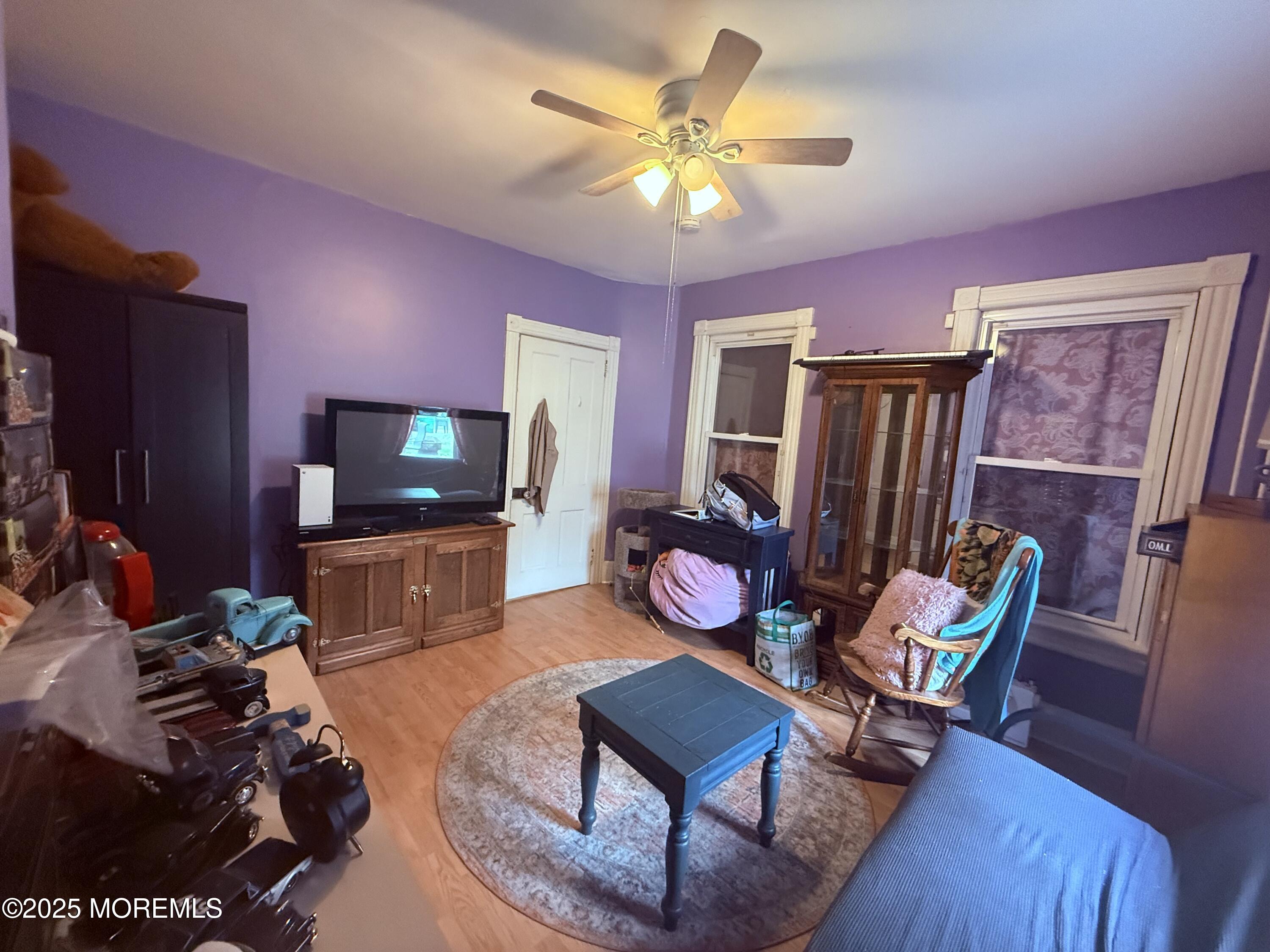 479 Line Road Matawan, NJ 07747 - Photo 23 of 32 a living room with furniture a flat screen tv and kitchen view