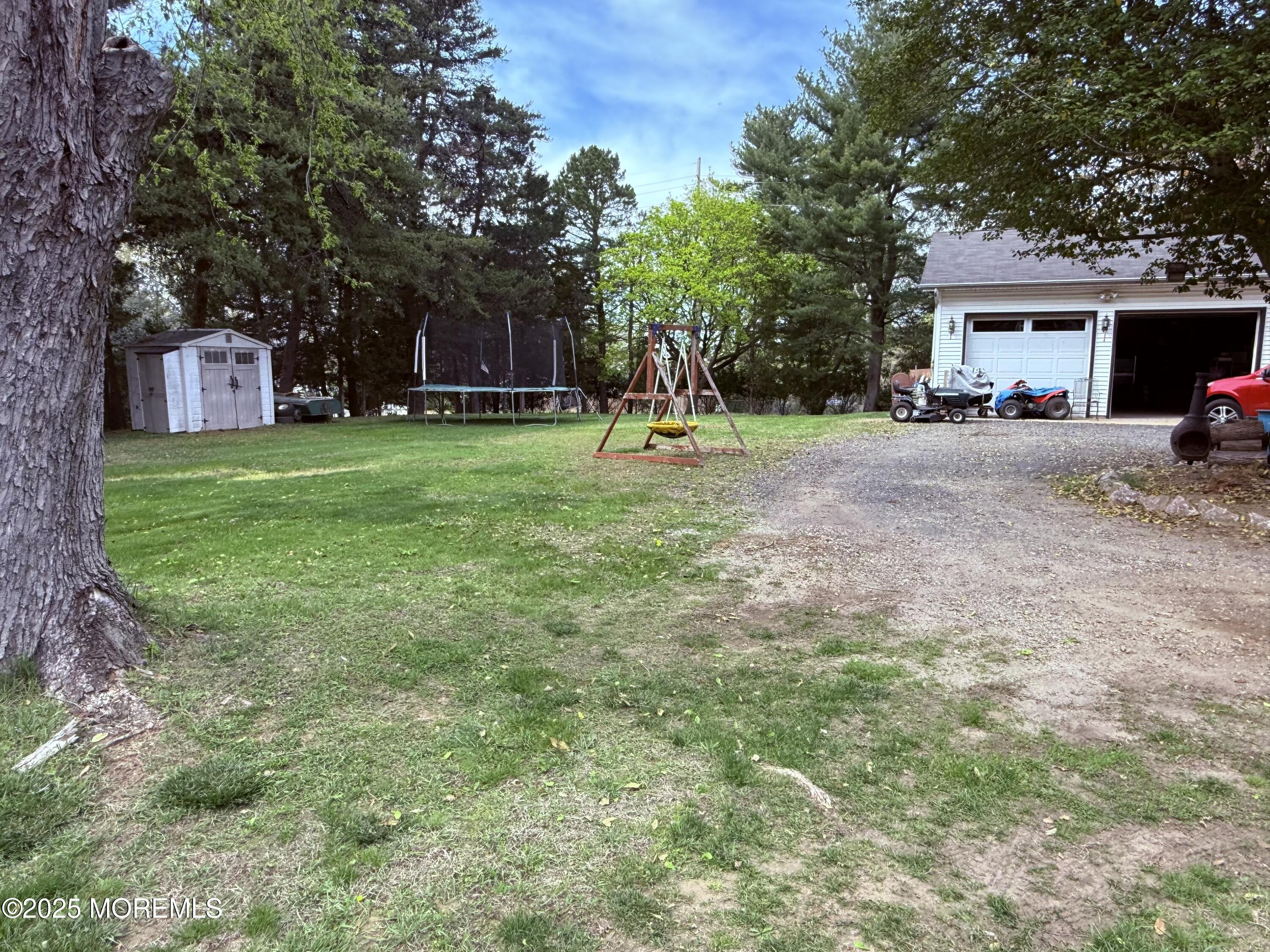 479 Line Road Matawan, NJ 07747 - Photo 9 of 32 a front view of a house with a garden and trees