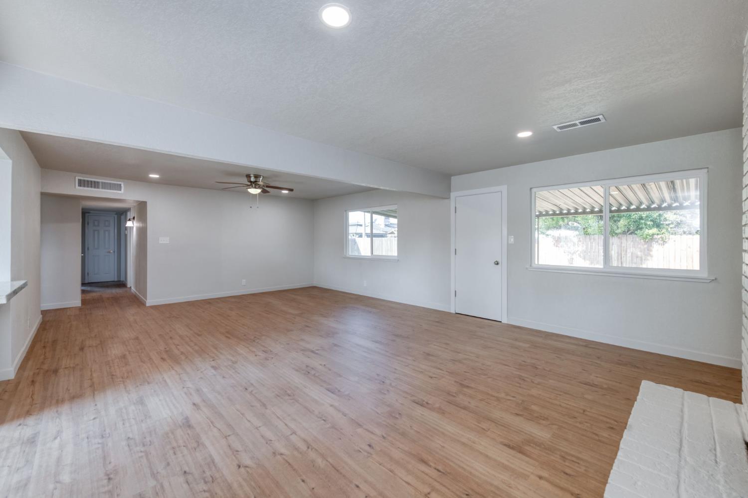 4031 East Pontiac Way Fresno, CA 93726 - Photo 12 of 46 a view of empty room with window and wooden floor