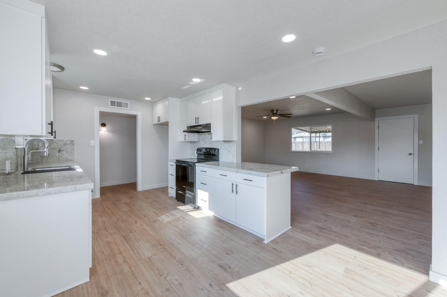 4031 East Pontiac Way Fresno, CA 93726 - Photo 15 of 46 a kitchen with stainless steel appliances kitchen island wooden cabinets and granite counter tops