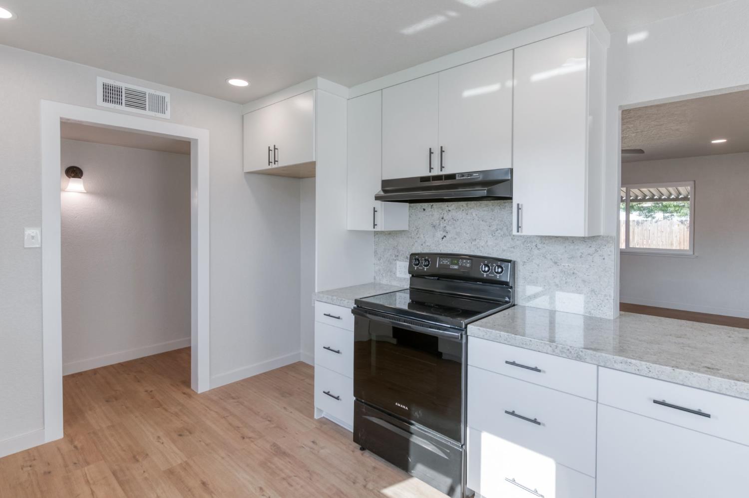 4031 East Pontiac Way Fresno, CA 93726 - Photo 17 of 46 a kitchen with a stove and a refrigerator