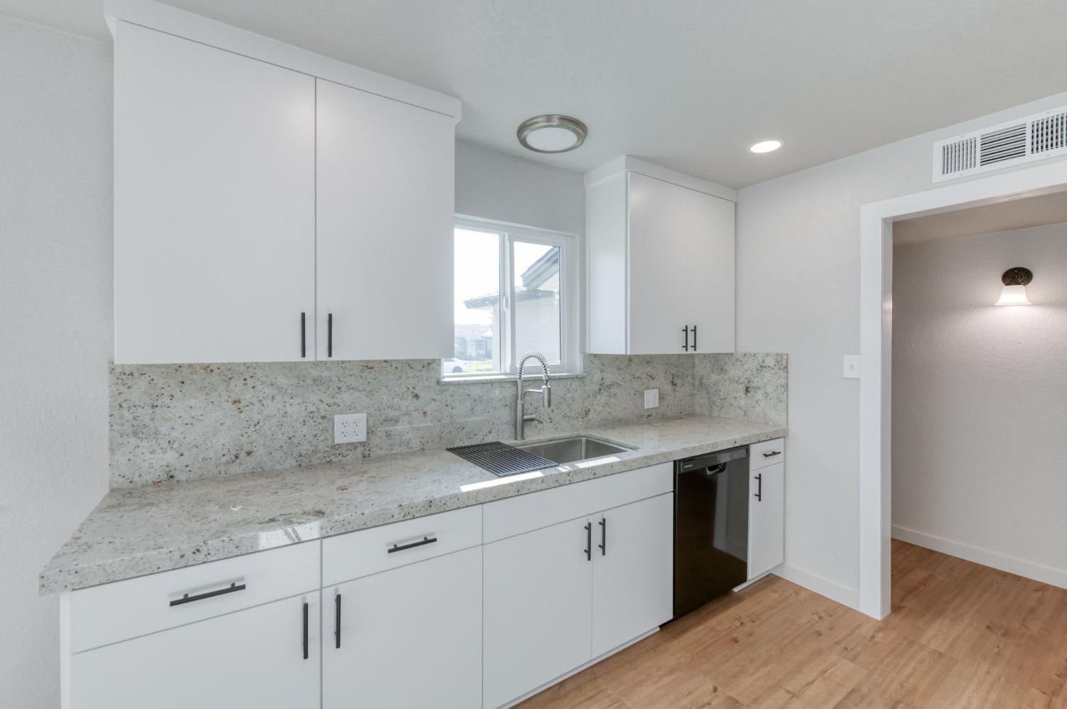 4031 East Pontiac Way Fresno, CA 93726 - Photo 18 of 46 a kitchen with a sink and cabinets