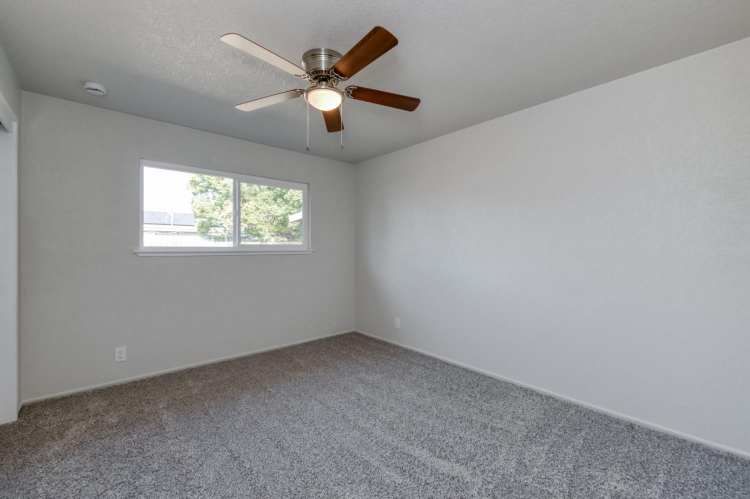 4031 East Pontiac Way Fresno, CA 93726 - Photo 27 of 46 an empty room with windows and fan