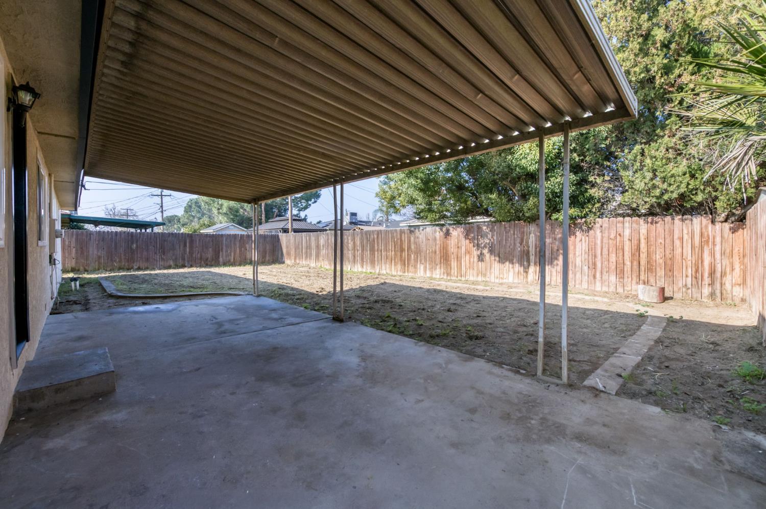 4031 East Pontiac Way Fresno, CA 93726 - Photo 29 of 46 a backyard of a house with a table and chairs