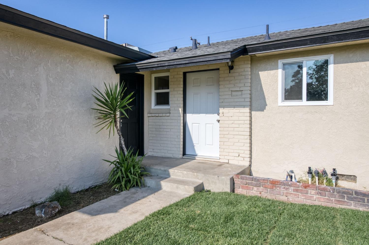 4031 East Pontiac Way Fresno, CA 93726 - Photo 7 of 46 a front view of a house with a yard