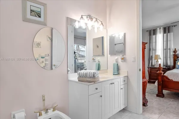 a bathroom with a mirror sink and toilet