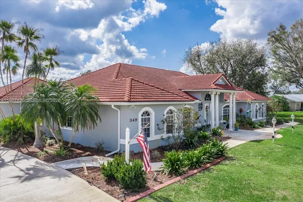 a front view of house with yard and green space