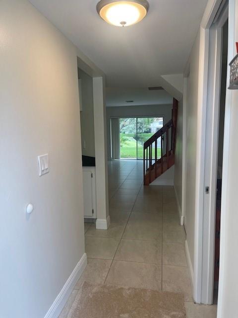 6373 Boca Circle Boca Raton, FL 33433 - Photo 3 of 22 a view of a hallway with wooden shelves