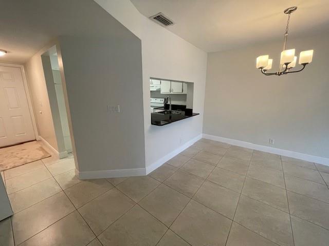 6373 Boca Circle Boca Raton, FL 33433 - Photo 10 of 22 a view of a kitchen with furniture and an empty room