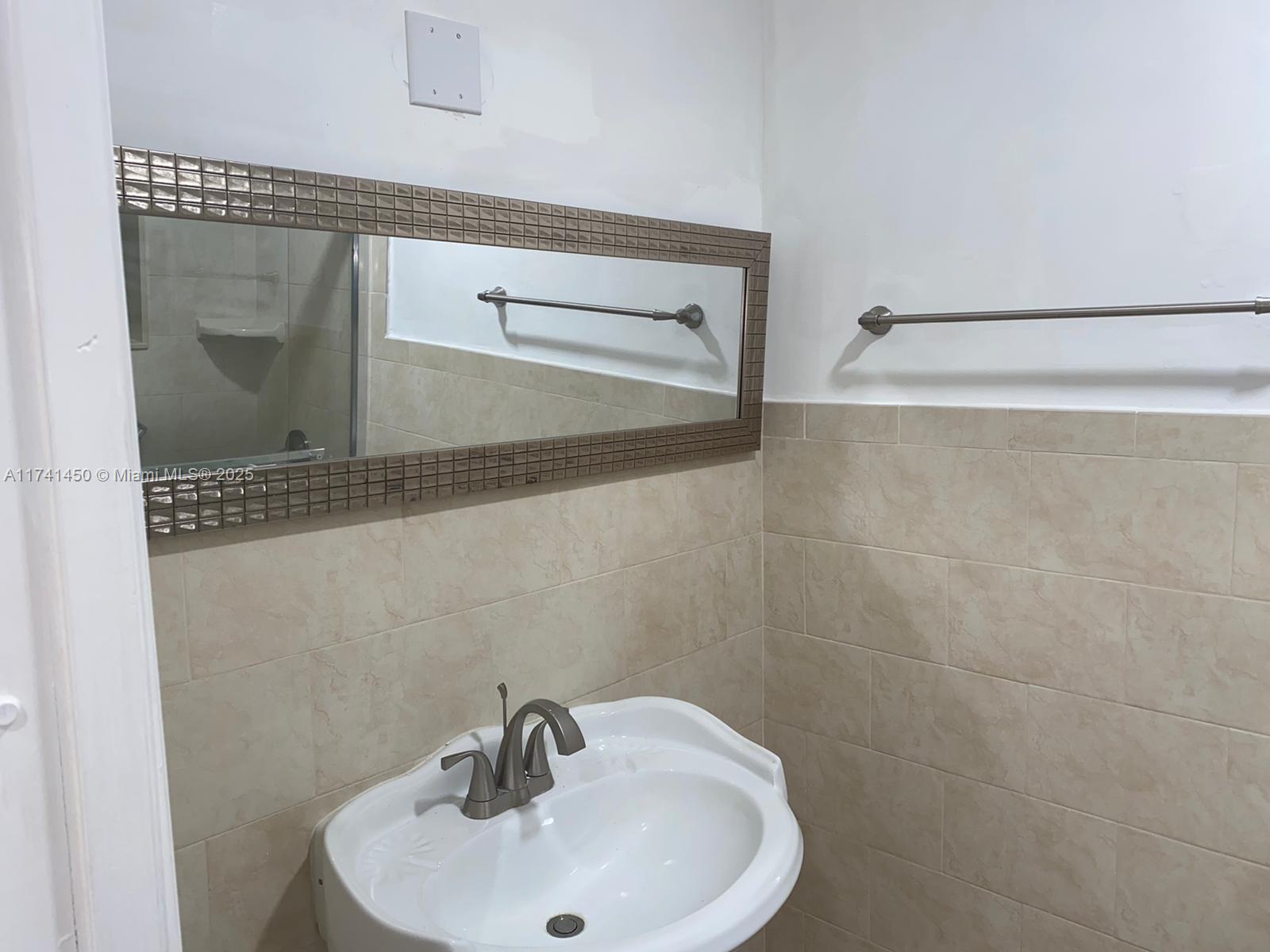 7775 West 29th Way, Unit 201 Hialeah, FL 33018 - Photo 13 of 14 a bathroom with a sink and a mirror