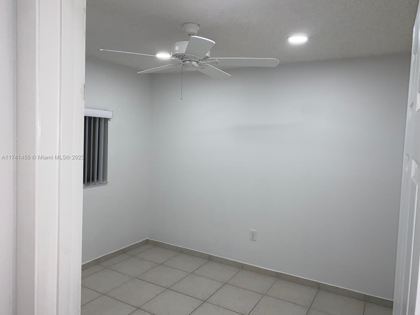 7775 West 29th Way, Unit 201 Hialeah, FL 33018 - Photo 8 of 14 an empty room with a bathroom