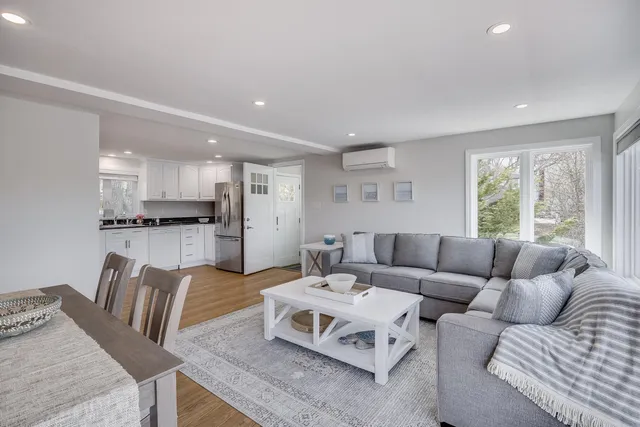 a kitchen with stainless steel appliances granite countertop a sink and cabinets with wooden floor