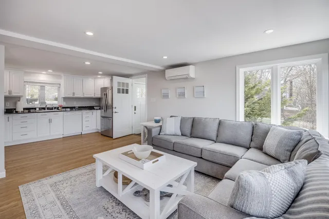 a kitchen with granite countertop white cabinets and stainless steel appliances