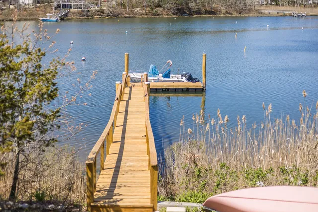 an aerial view of a house with a yard and lake view