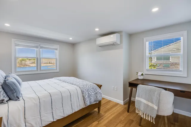 a spacious bedroom with a bed and a window