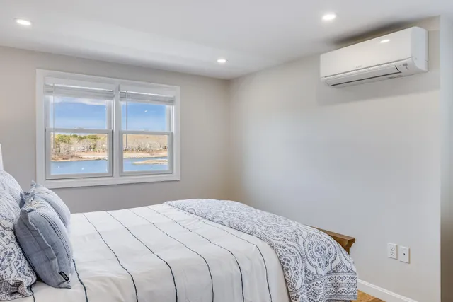 a bedroom with a large bed and a night stand