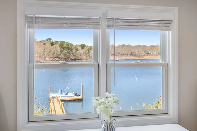 a large bed sitting in a bedroom next to a window