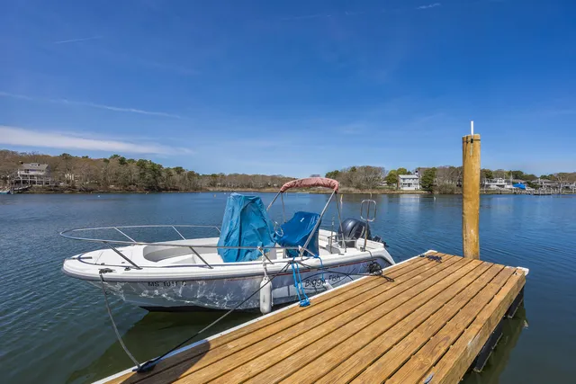 a view of a house with roof deck and a small yard