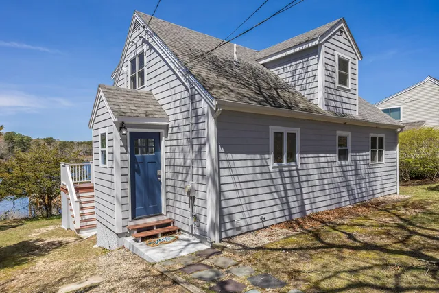a living room with furniture wooden floor and a floor to ceiling window