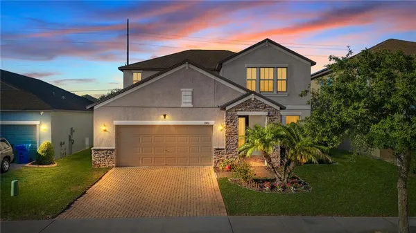 a front view of a house with a yard and garage