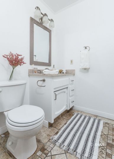 640 Sydnor Avenue Ridgecrest, CA 93555 - Photo 28 of 28 a bathroom with a granite countertop toilet sink and mirror