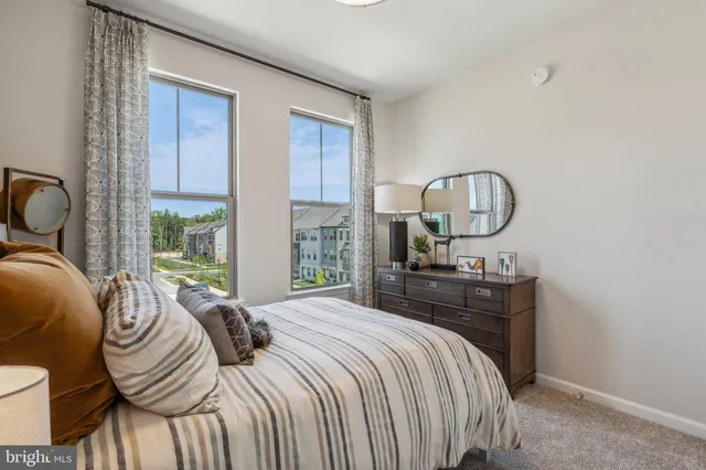 a bedroom with a bed chair and window