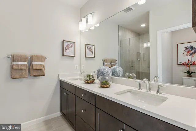 a bathroom with a sink double vanity and mirror