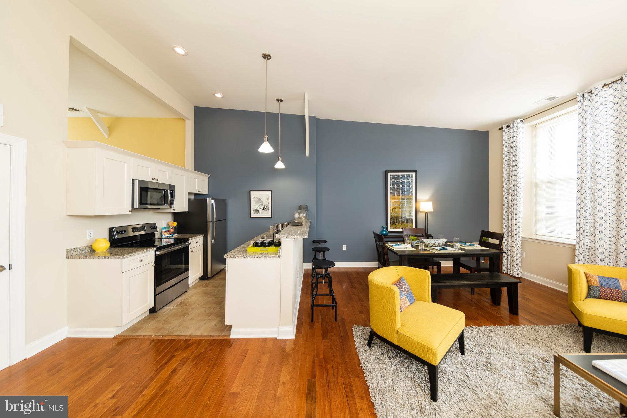 101 Wells Baltimore Md 21230, Unit 2BR Baltimore, MD 21230 - Photo 33 of 46 a living room with furniture kitchen view and a large window