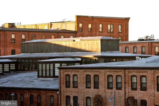 a view of a brick building next to a yard