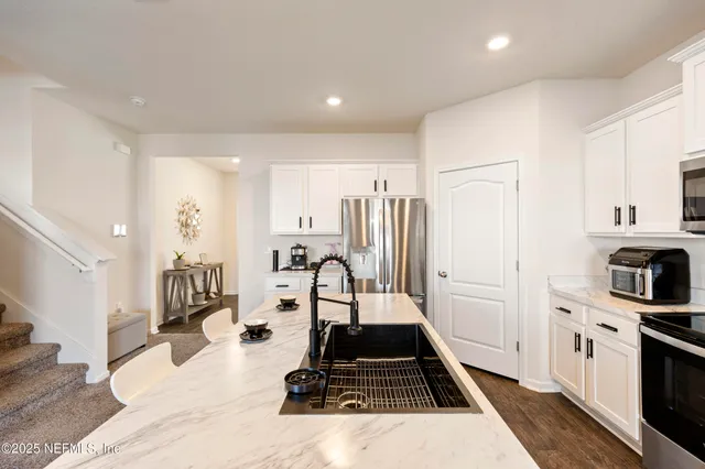 a kitchen with sink a stove and refrigerator