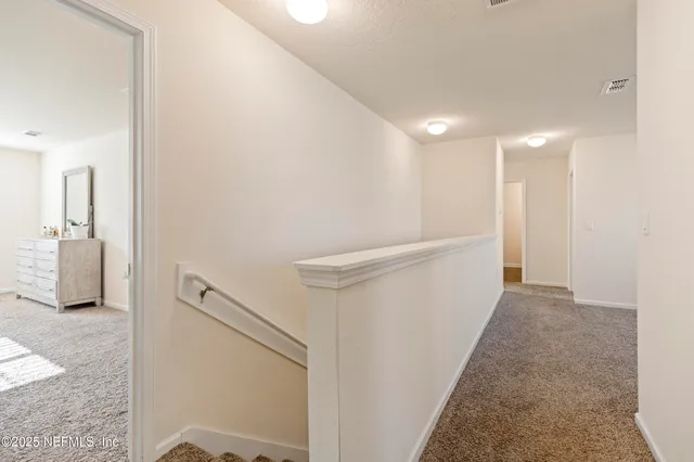 a view of a hallway with staircase