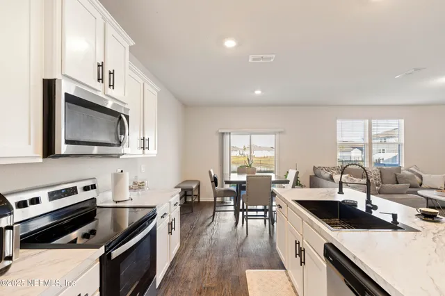 a kitchen with lots of counter top space and stainless steel appliances