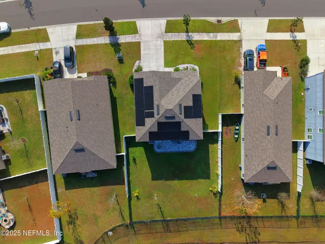 an aerial view of a house with a swimming pool