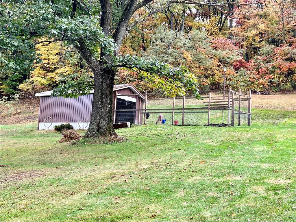 159 Martin Farm Road Dunbar, PA 15431 - Photo 19 of 22 a view of backyard with large trees and wooden fence