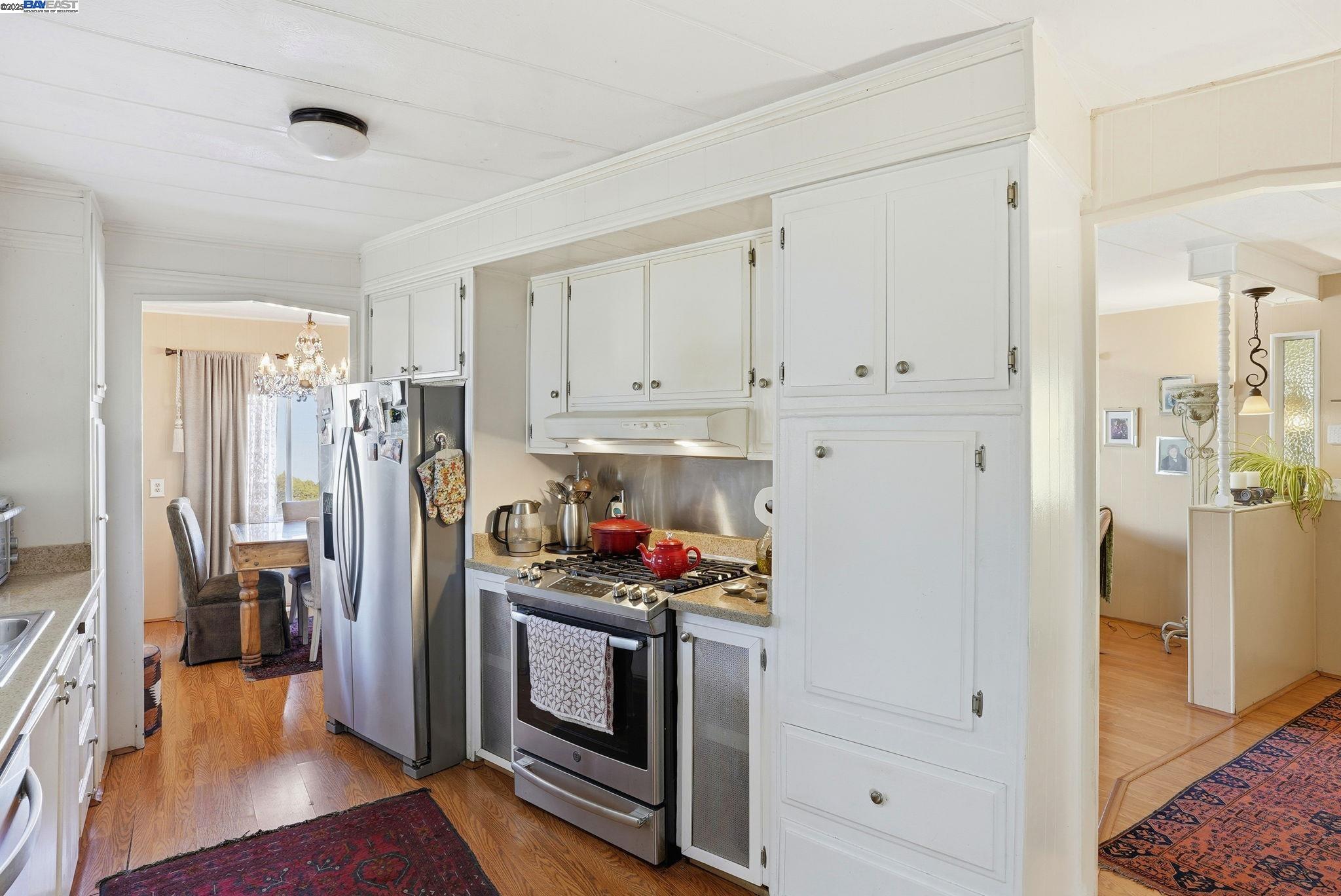 4141 Deep Creek Road, Unit 89 Fremont, CA 94555 - Photo 16 of 54 a kitchen with stainless steel appliances a stove a refrigerator and a cabinets