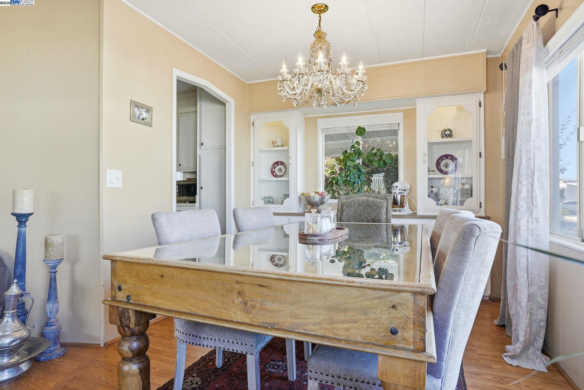 4141 Deep Creek Road, Unit 89 Fremont, CA 94555 - Photo 20 of 54 a view of a dining room with furniture a chandelier and wooden floor