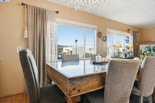 a dining room with furniture and a window